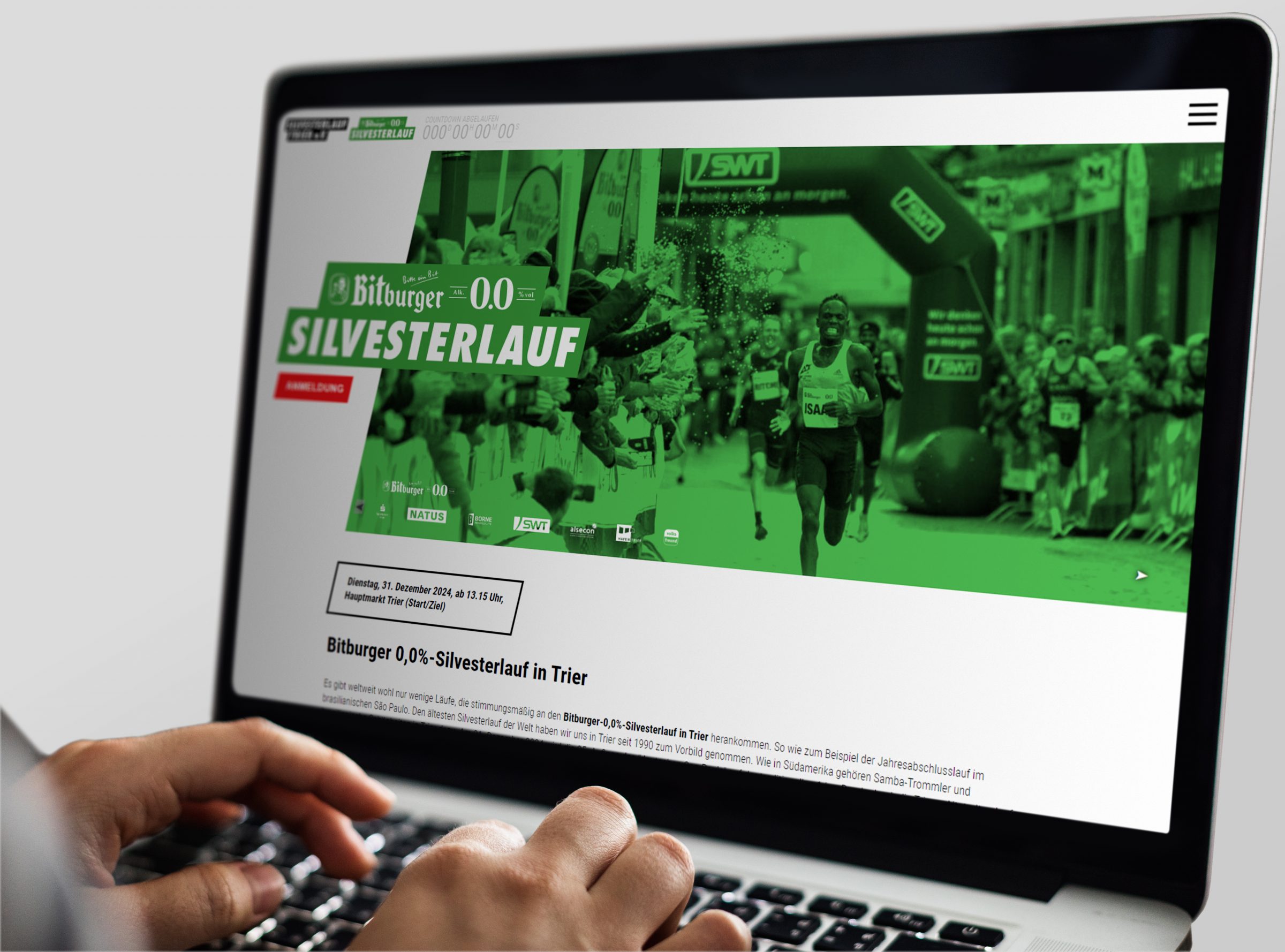 Die Startseite der Webseite des Bitburger 0,0%-Silvesterlaufs in Trier, dargestellt auf einem Laptop.